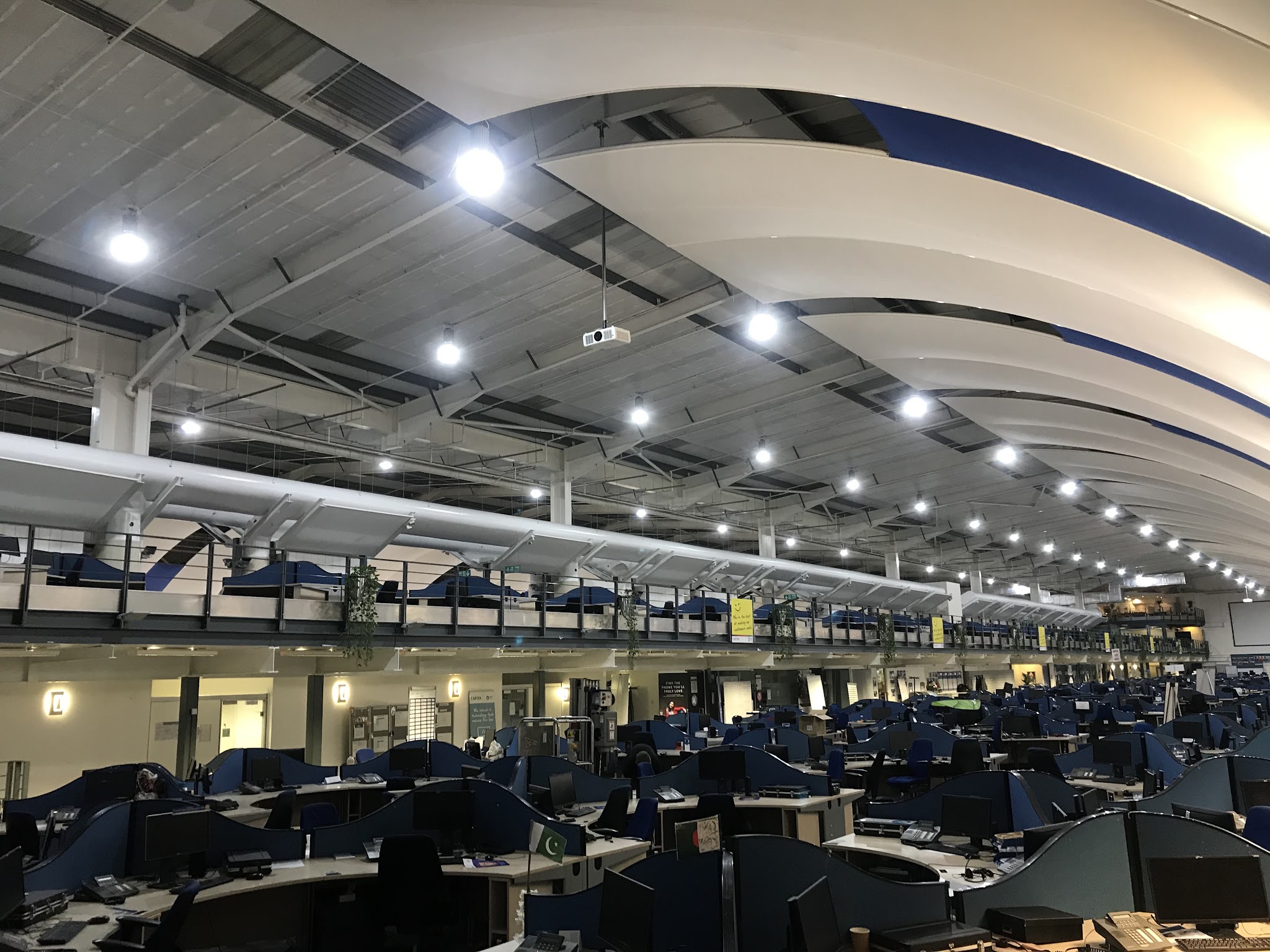 Open-plan office lit by rows of LED downlights