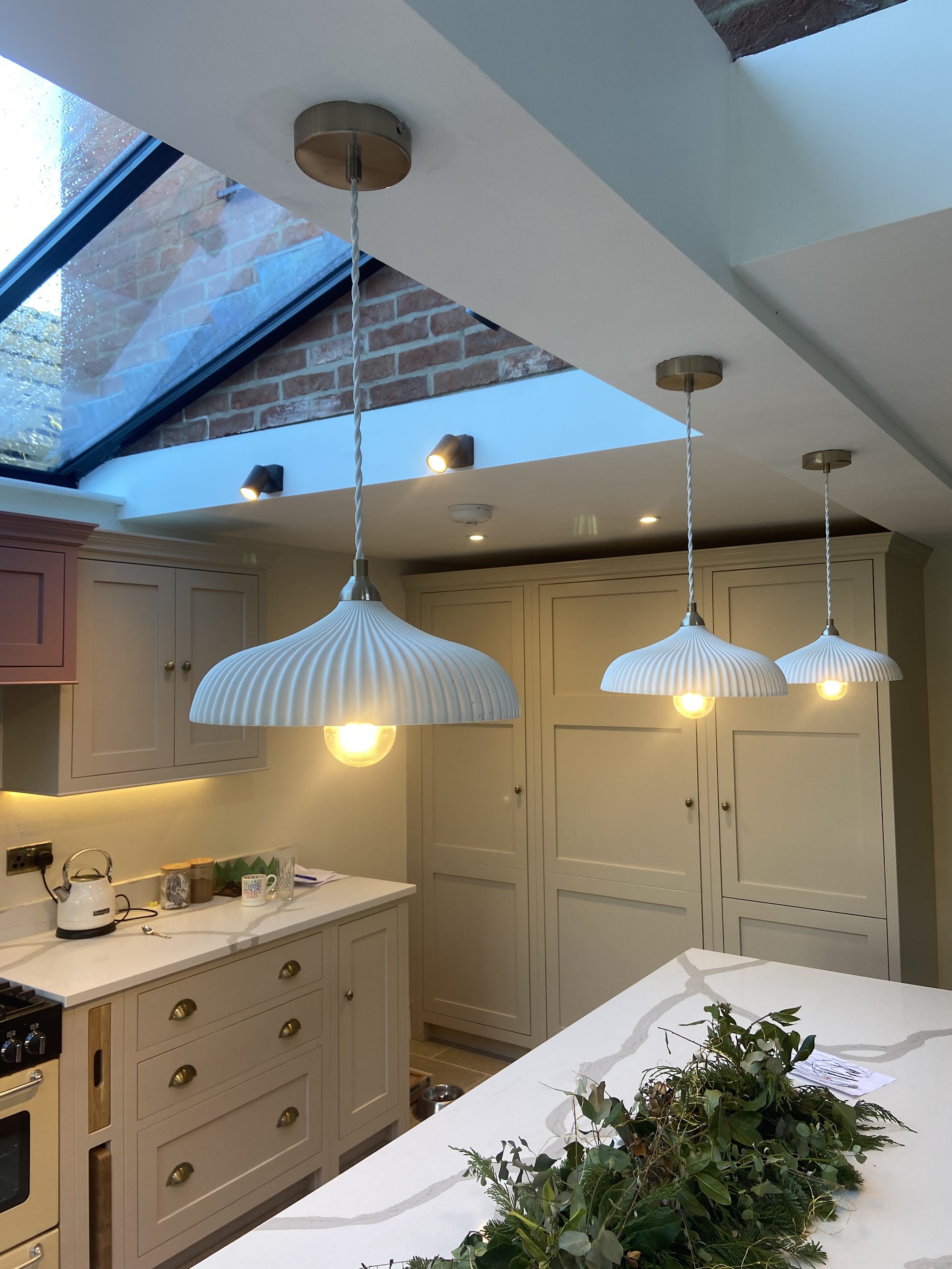 Kitchen with three ribbed pendant lights, downlights and a roof lantern