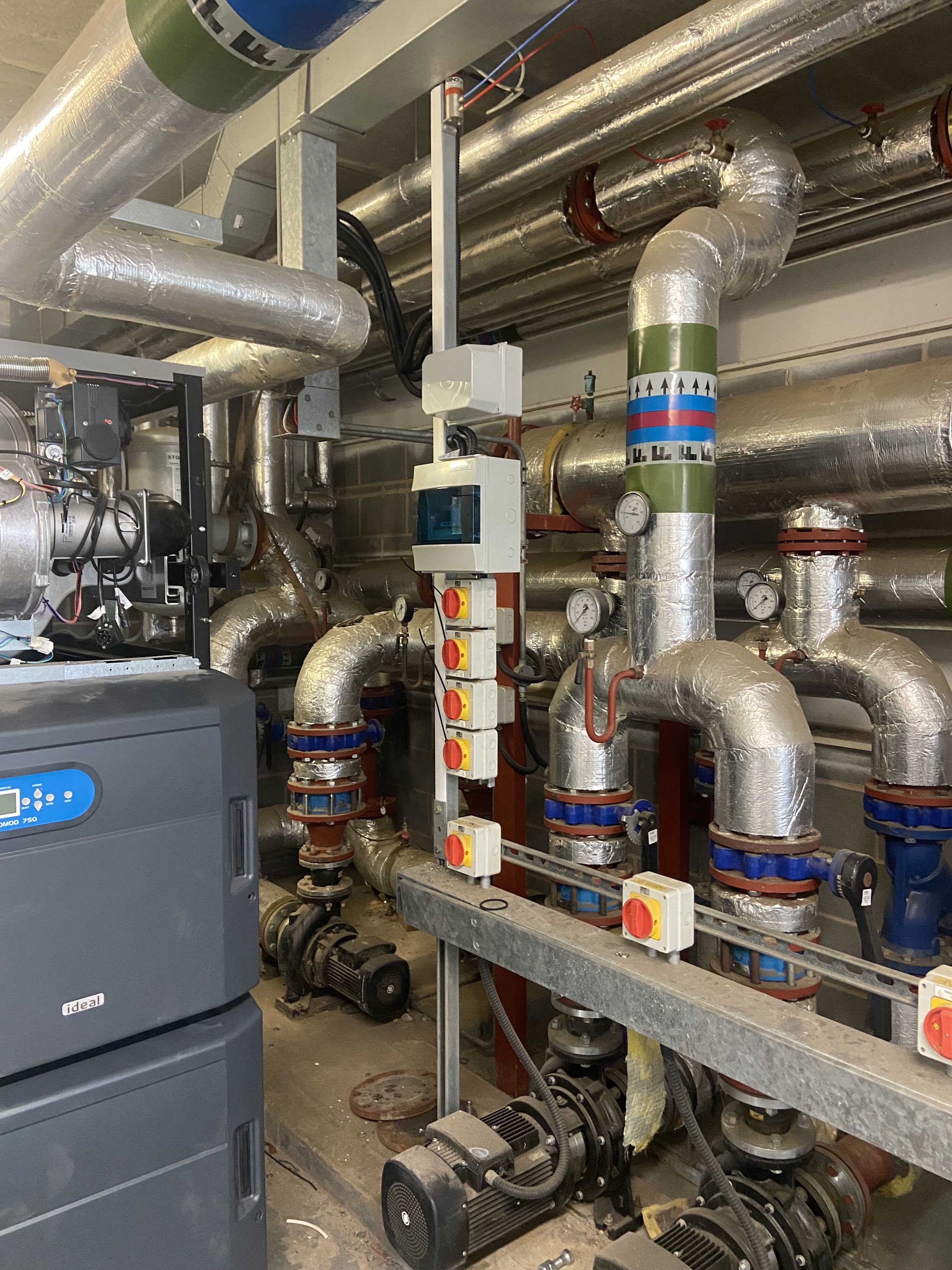 Plant room with pumps, lagged pipework and isolator switches